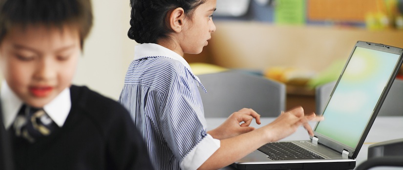 “student-on-laptop-in-classroom“