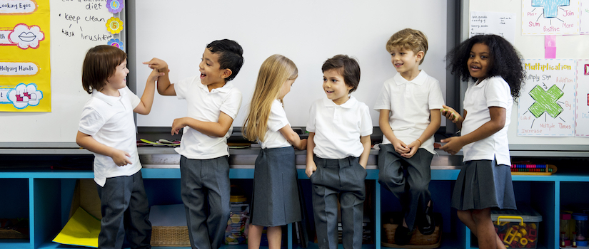 “students-standing-at-front-of-classroom“