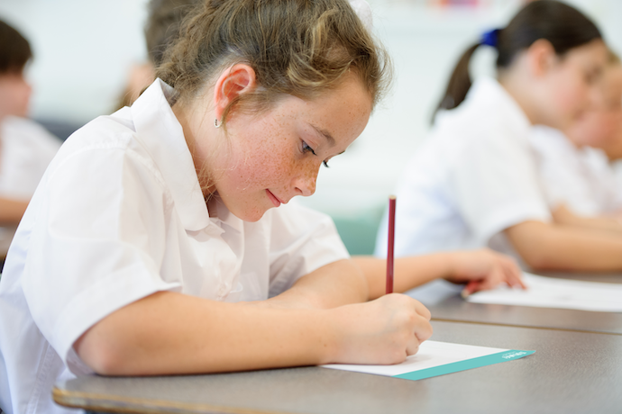 student writing on worksheet