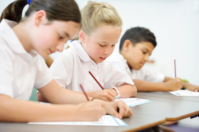 students in classroom completing test